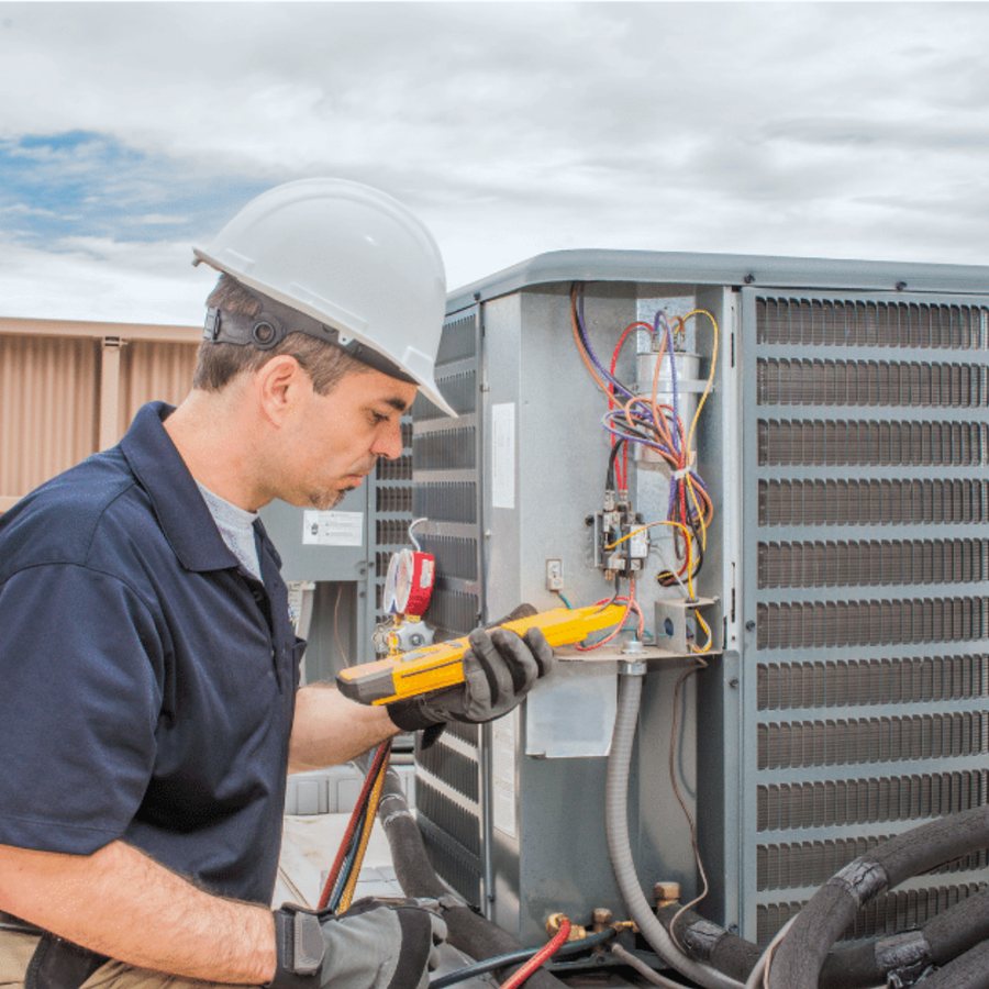 Newmarket Heating & Cooling HVAC technician servicing a system